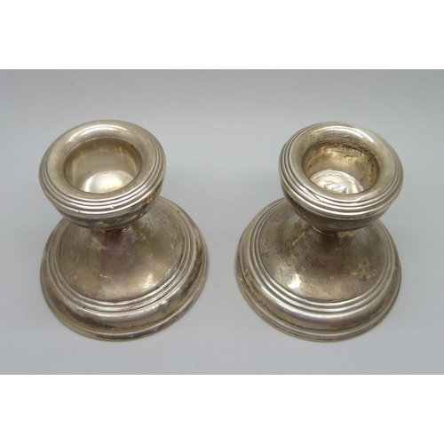 853 - A pair of small silver candlesticks