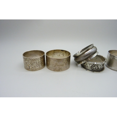 858 - Five silver napkin rings, one with continental mark, 124g, and a plated napkin ring