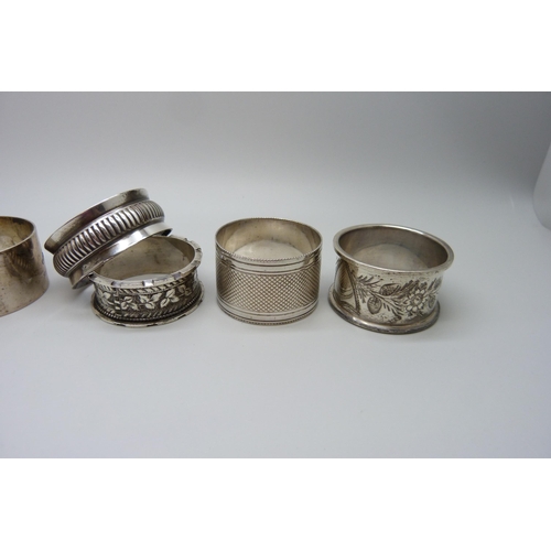 858 - Five silver napkin rings, one with continental mark, 124g, and a plated napkin ring