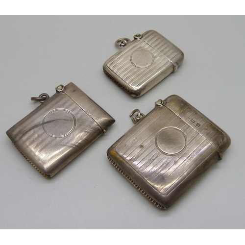 883 - Three silver vesta cases, 64g