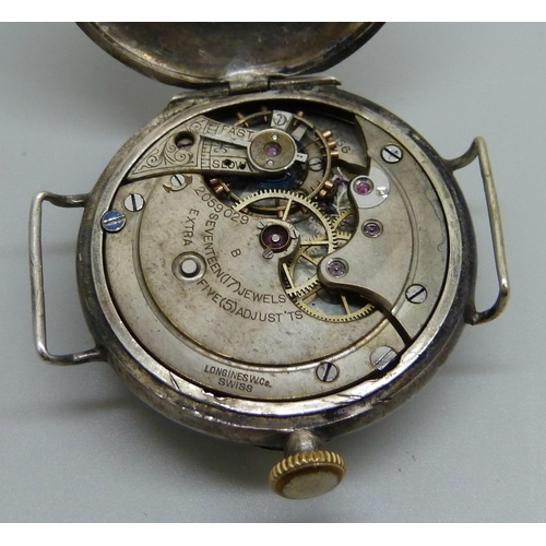 976 - A Longines silver cased wristwatch with engraved case back, the case marked A.W.C. Co., 32mm case