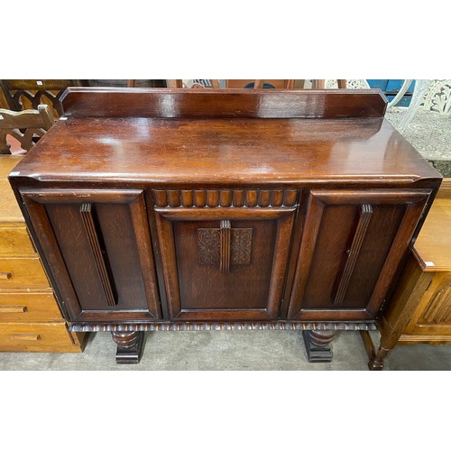 216 - A carved oak sideboard, carved oak bureau and an oak chest of drawers