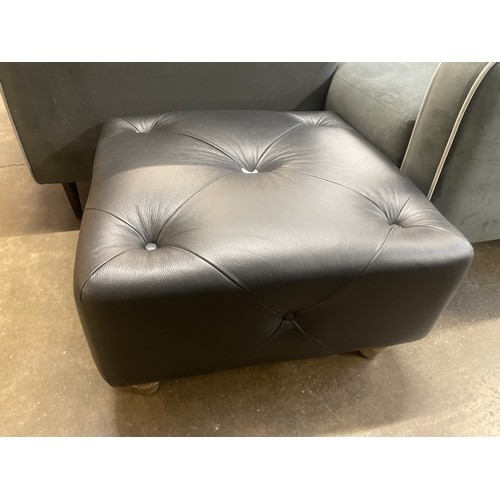 3006 - A black leather Chesterfield footstool