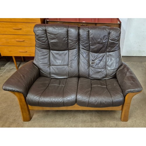 16 - A Norweigan Ekornes teak and brown leather reclining two seater sofa