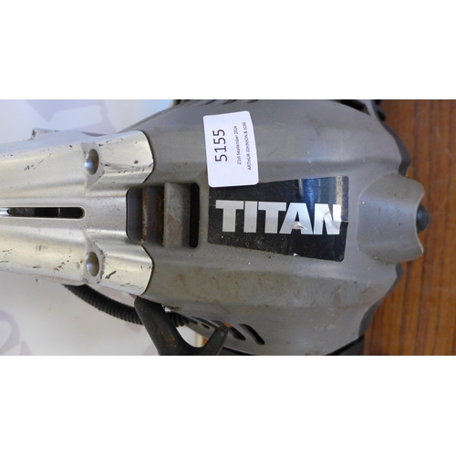 5155 - A Titan  TTK587EIDO petrol multitool with strimmer, chain saw and hedge cutter attachments