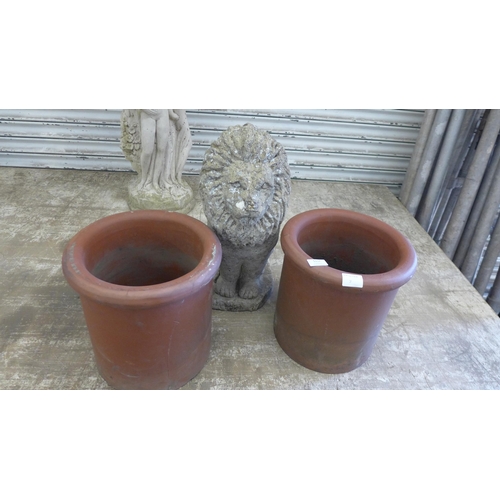 5157 - A concrete stone effect lion with 2 terracotta chimney toppers