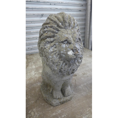 5157 - A concrete stone effect lion with 2 terracotta chimney toppers