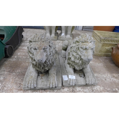 5164 - A pair of concrete stone effect laying lion garden ornaments