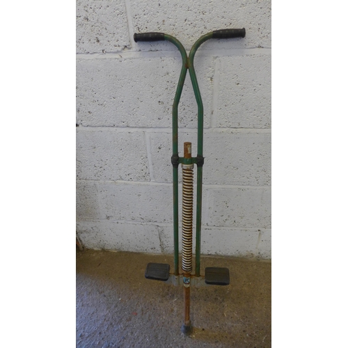 5173 - A brass handrail and a vintage pogo stick