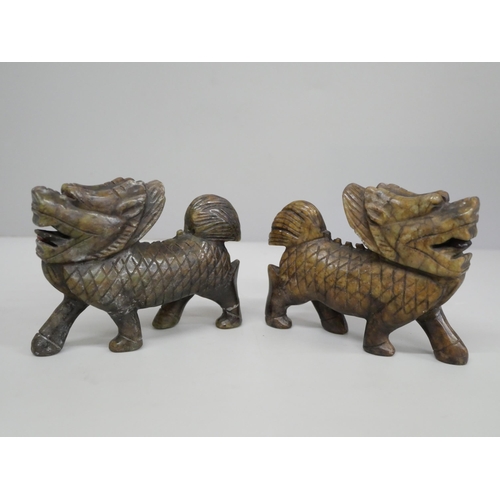 625 - Two carved jade/soapstone figures of foo dogs, each 10.5cm long, one a/f (legs)