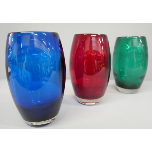 630 - A set of three coloured glass vases, 15cm