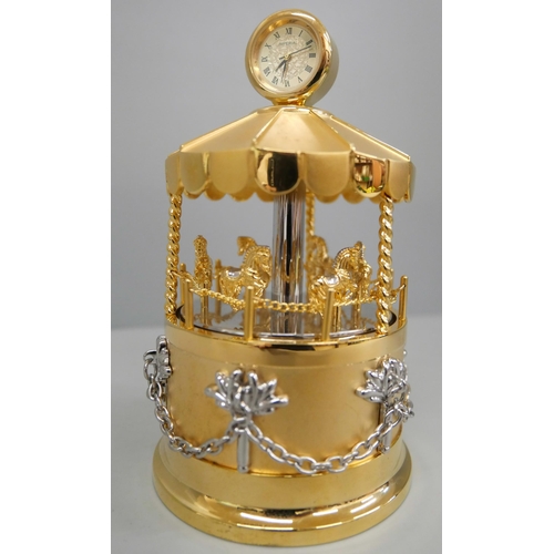 640 - A Sankyo musical table clock in the form of a carousel