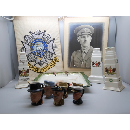 667 - A black and white photograph of a WWI officer, a Bedfordshire and Hertfordshire regimental needlewor... 