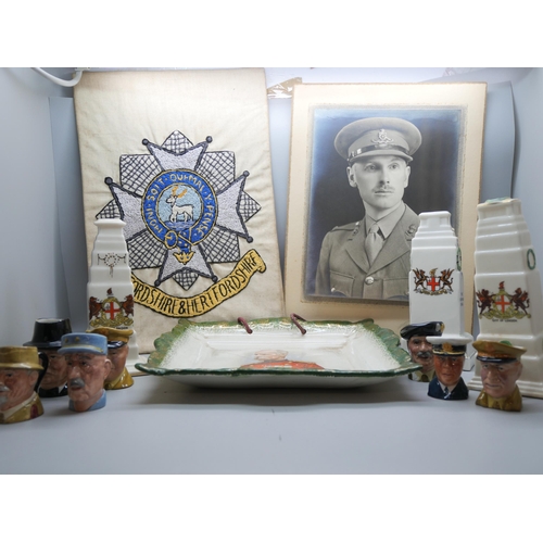 667 - A black and white photograph of a WWI officer, a Bedfordshire and Hertfordshire regimental needlewor... 