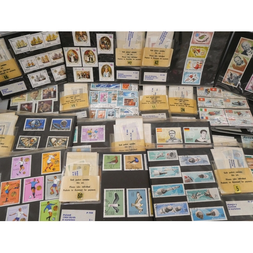 678 - A collection of vintage stamp sets in dealers folders with a display and packs of stamps batched up,... 