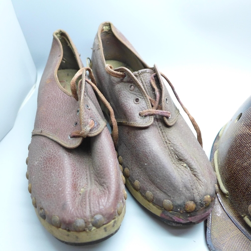 747 - A small child's pit helmet, marked 'A Campbell Head Cradle' and a pair of clogs, marked 1945 and wit... 