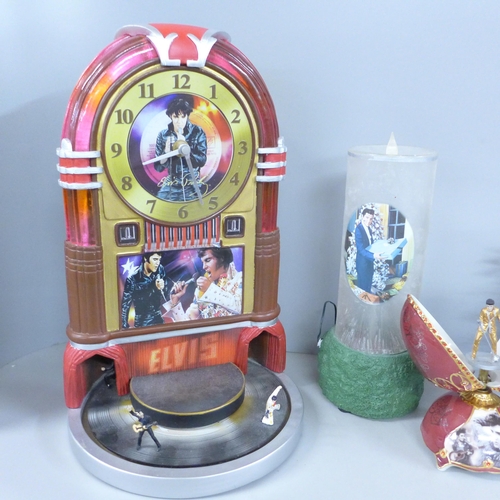 774 - A box of Elvis Presley, Bradford Exchange items, jukebox clock, musical egg and candle with wreath