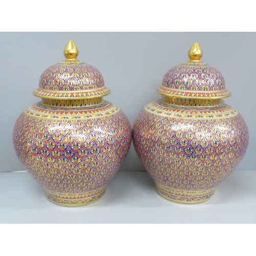 791 - A pair of Thai Benjayong lidded vases with colourful enameled detail, 30cm