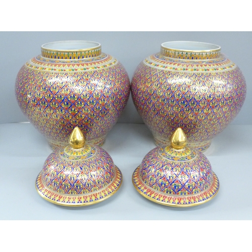 791 - A pair of Thai Benjayong lidded vases with colourful enameled detail, 30cm