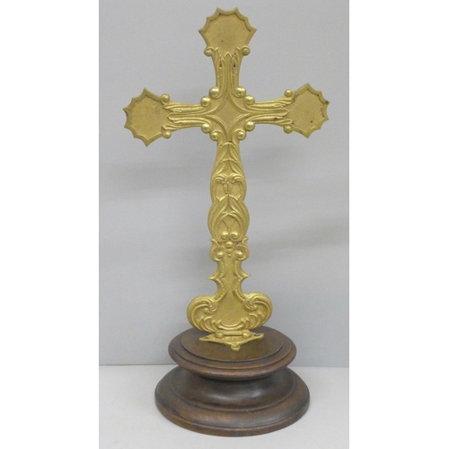 794 - A folding brass crucifix on a turned wooden base, 36.5cm