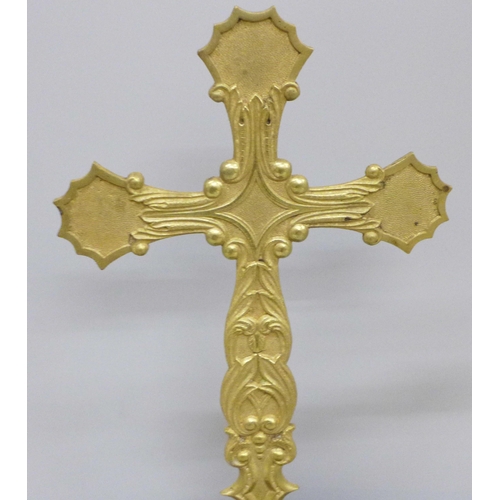 794 - A folding brass crucifix on a turned wooden base, 36.5cm