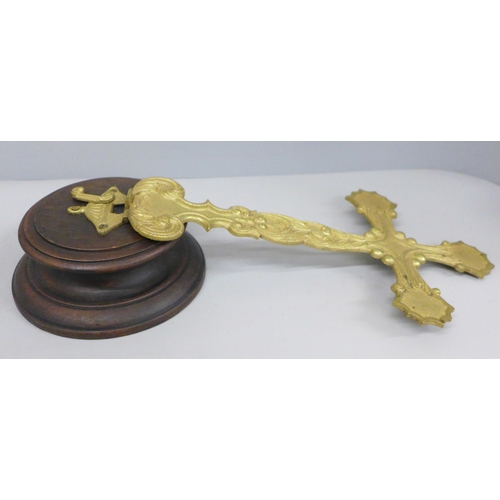 794 - A folding brass crucifix on a turned wooden base, 36.5cm