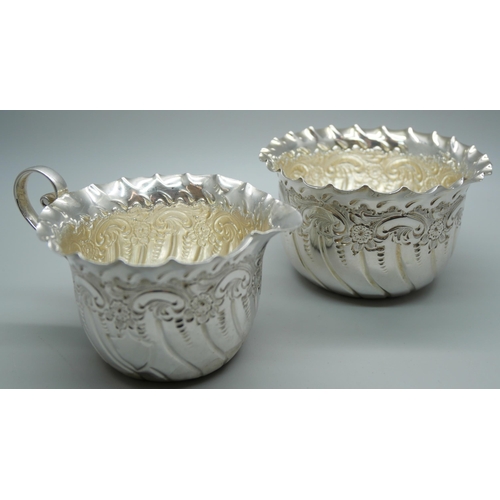 841 - An embossed silver cream jug and sugar bowl, Sheffield 1889, 95g