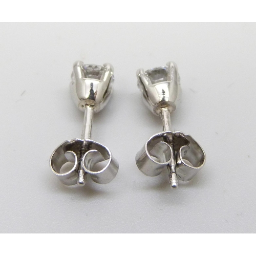 874 - A pair of hallmarked platinum diamond stud earrings, 0.81 carat total diamond weight