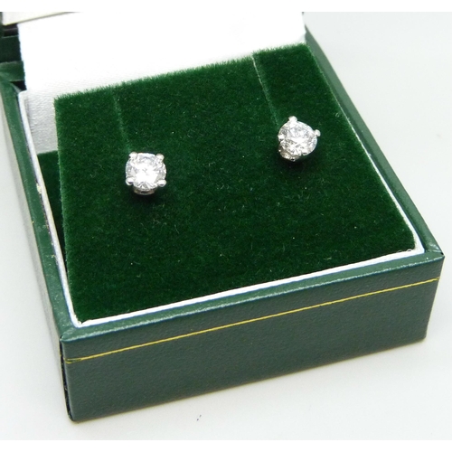 874 - A pair of hallmarked platinum diamond stud earrings, 0.81 carat total diamond weight