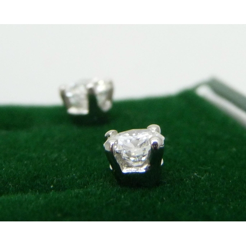 874 - A pair of hallmarked platinum diamond stud earrings, 0.81 carat total diamond weight