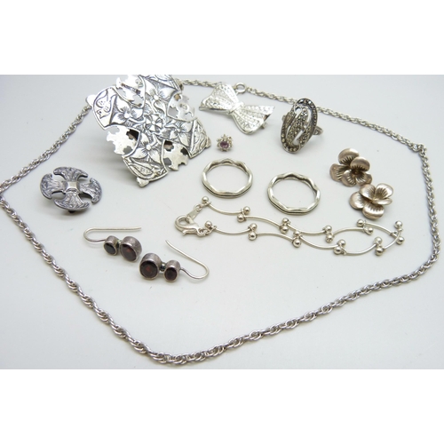 883 - A large stone set cross pendant, a silver cross brooch, a silver ring, etc.