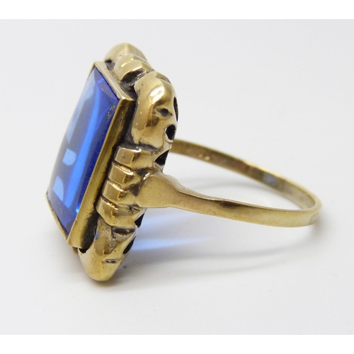 907 - A silver gilt cushion shape blue stone ring, O