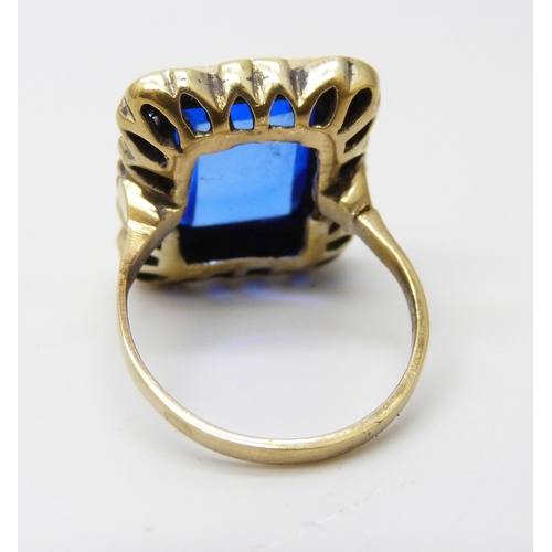 907 - A silver gilt cushion shape blue stone ring, O