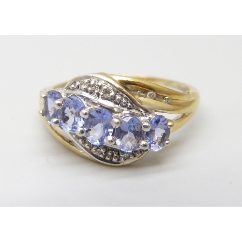 915 - A silver gilt ring set with tanzanite and diamond accents, M