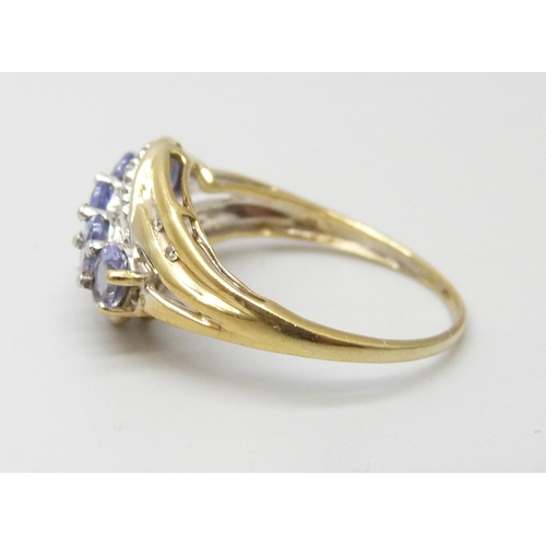 915 - A silver gilt ring set with tanzanite and diamond accents, M