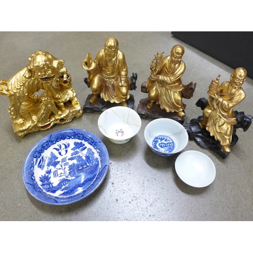 994 - A collection of oriental china, four gilt painted wooden figures, three bowls and a dish, (Chinese b... 