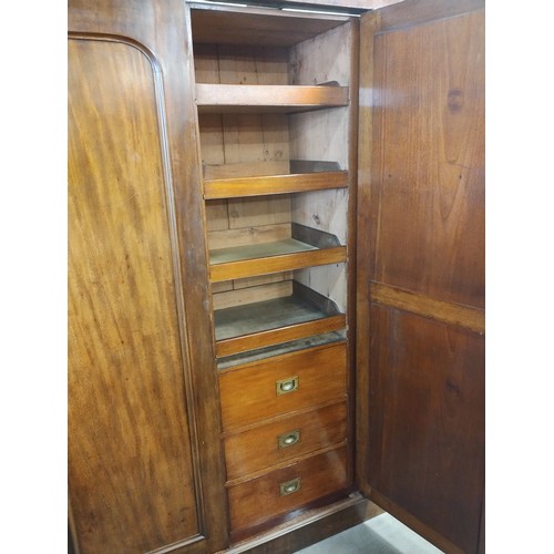 100 - A Victorian mahogany fitted three door wardrobe