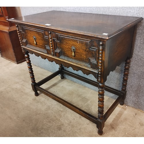 102 - A Jacobean Revival oak geometric moulded two drawer side table