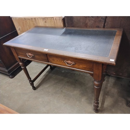 105 - A Victorian ash two drawer writing table