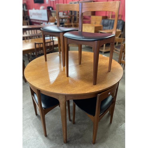 54 - A Nathan teak circular extending dining table and six chairs