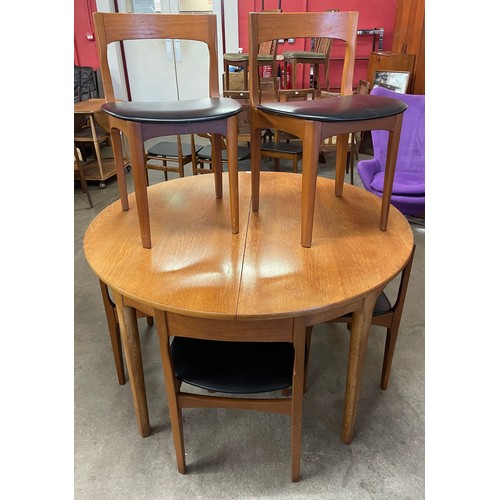 54 - A Nathan teak circular extending dining table and six chairs