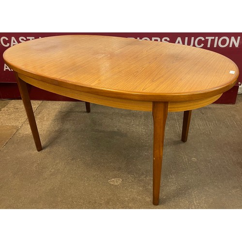 62 - A teak oval extending dining table