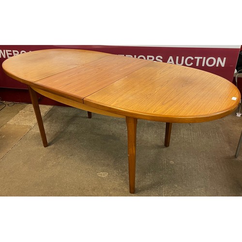 62 - A teak oval extending dining table