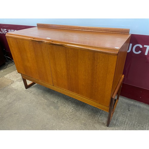 63 - A teak two door sideboard