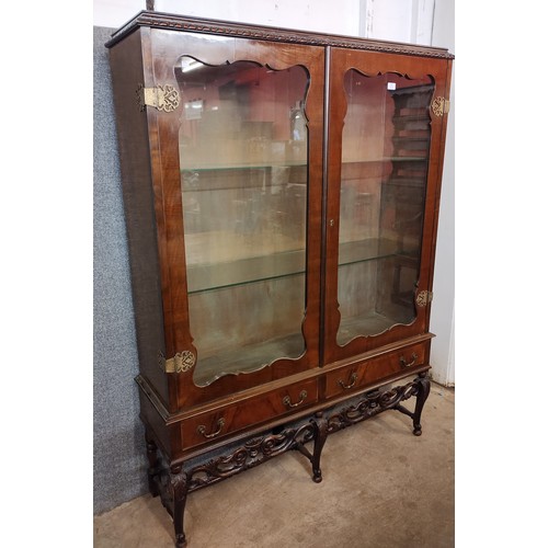 121 - A Dutch style carved walnut and burr walnut two door display cabinet