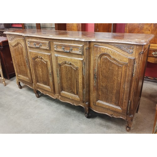 122 - A 19th century style French Breton carved oak four door sideboard