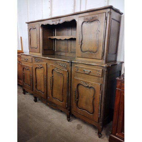 142 - An 18th Century style French Breton carved oak sideboard