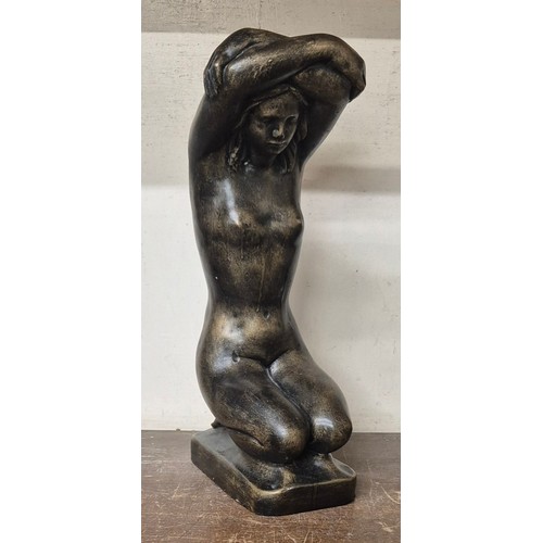 353 - A bronze effect figure of a kneeling female nude