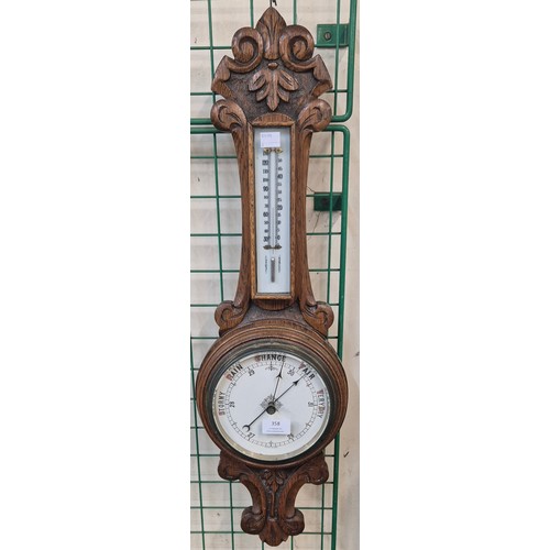 358 - An early 20th century carved oak aneroid barometer