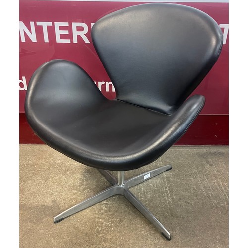 76 - An Arne Jacobsen style black leather and chrome Swan chair